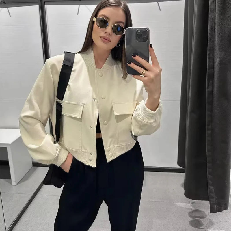 Stylish white bomber jacket for women with buttons, long sleeves, and a cropped design. Perfect for autumn and winter.