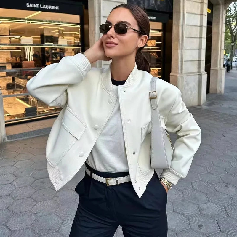 Stylish white bomber jacket for women with buttons, long sleeves, and a cropped design. Perfect for autumn and winter.