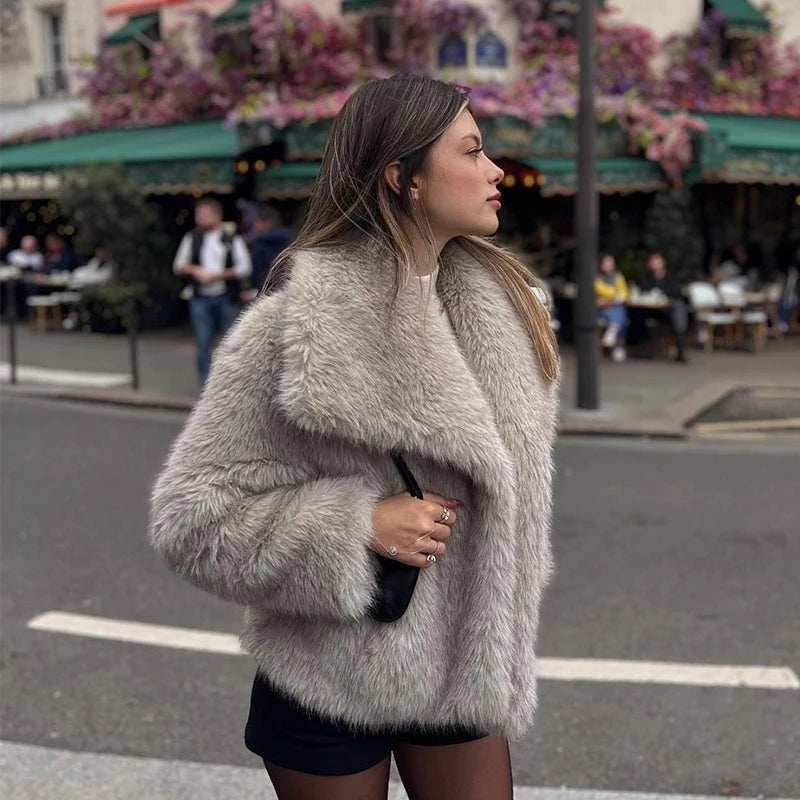 Luxurious gradient faux fur coat for women with a big fluffy collar. High-street winter fashion.