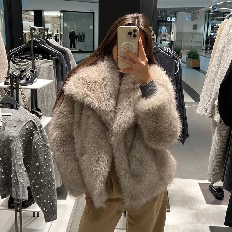 Luxurious gradient faux fur coat for women with a big fluffy collar. High-street winter fashion.